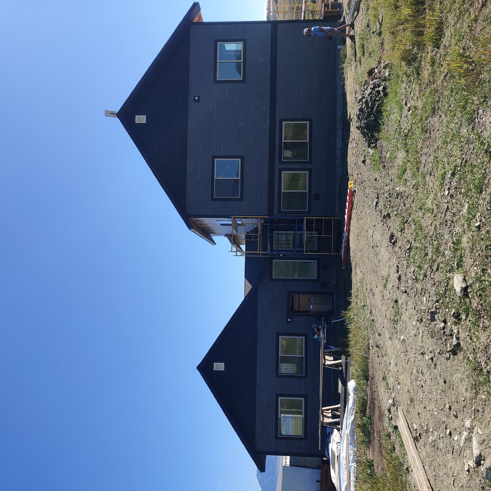 Finished home exterior with dark siding